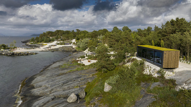 a house on a hill by a river